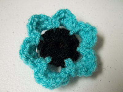 turquoise and black crochet small star flower clip